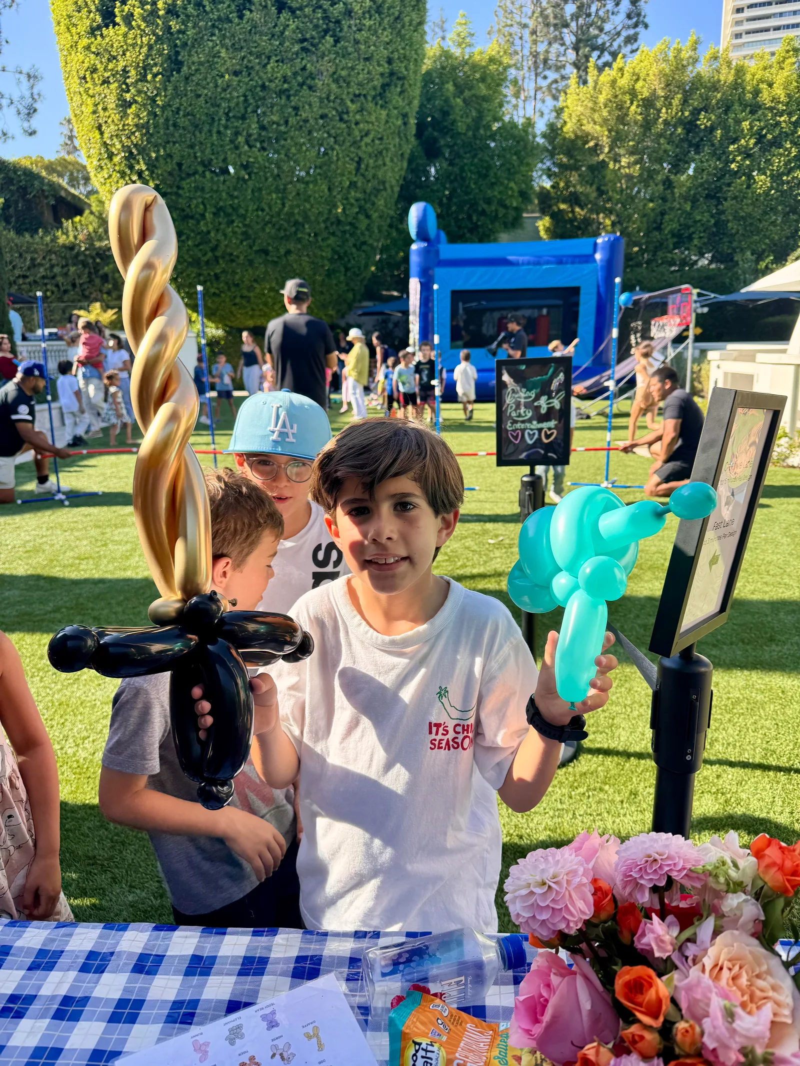 Balloon artist table at a bounce house party by Happy Faces LA
