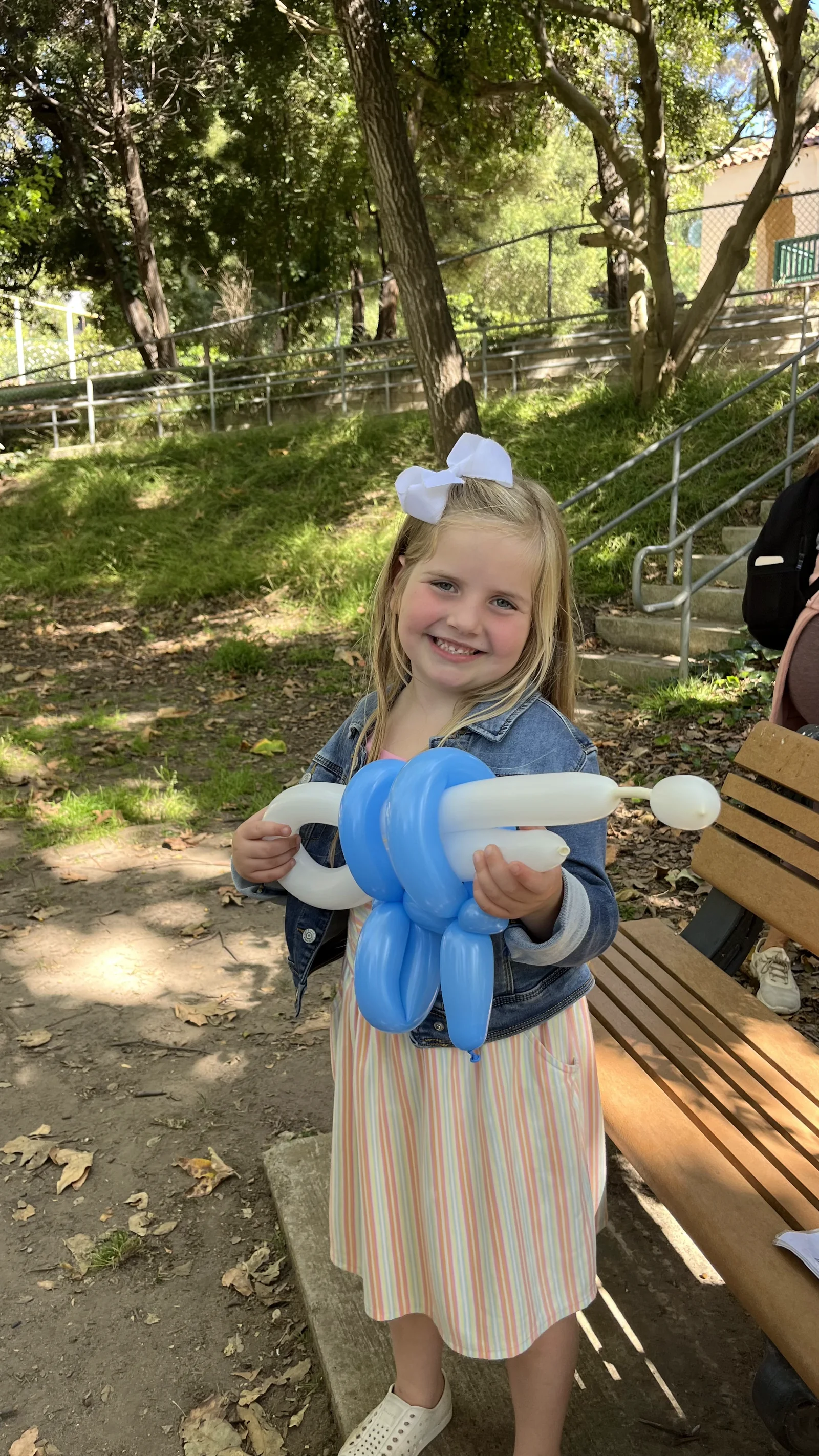 Blue balloon animal at an outdoor party by Happy Faces LA