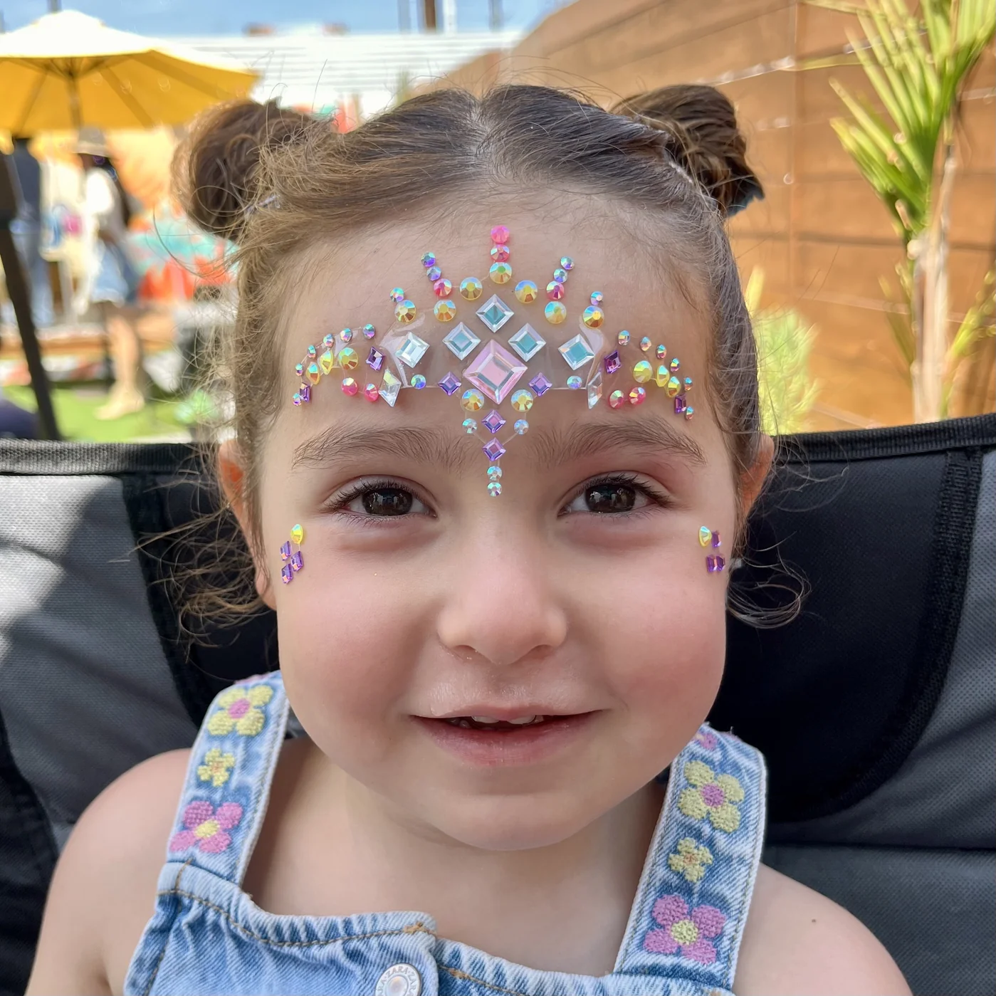 Iridescent face gem crown on forehead at a birthday party in Los Angeles by Happy Faces LA