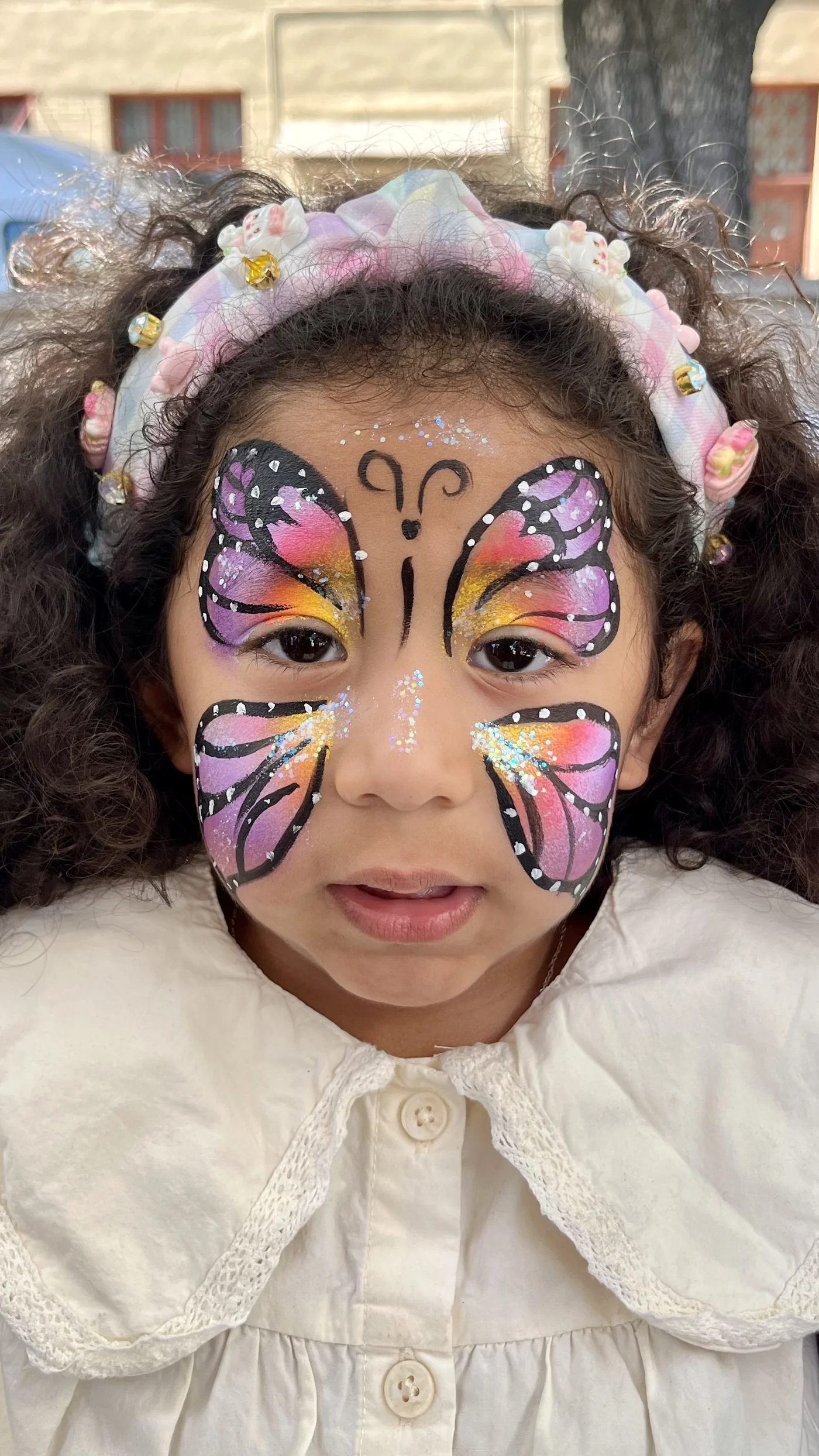 Vibrant butterfly face painting by Happy Faces LA at a birthday party in Los Angeles