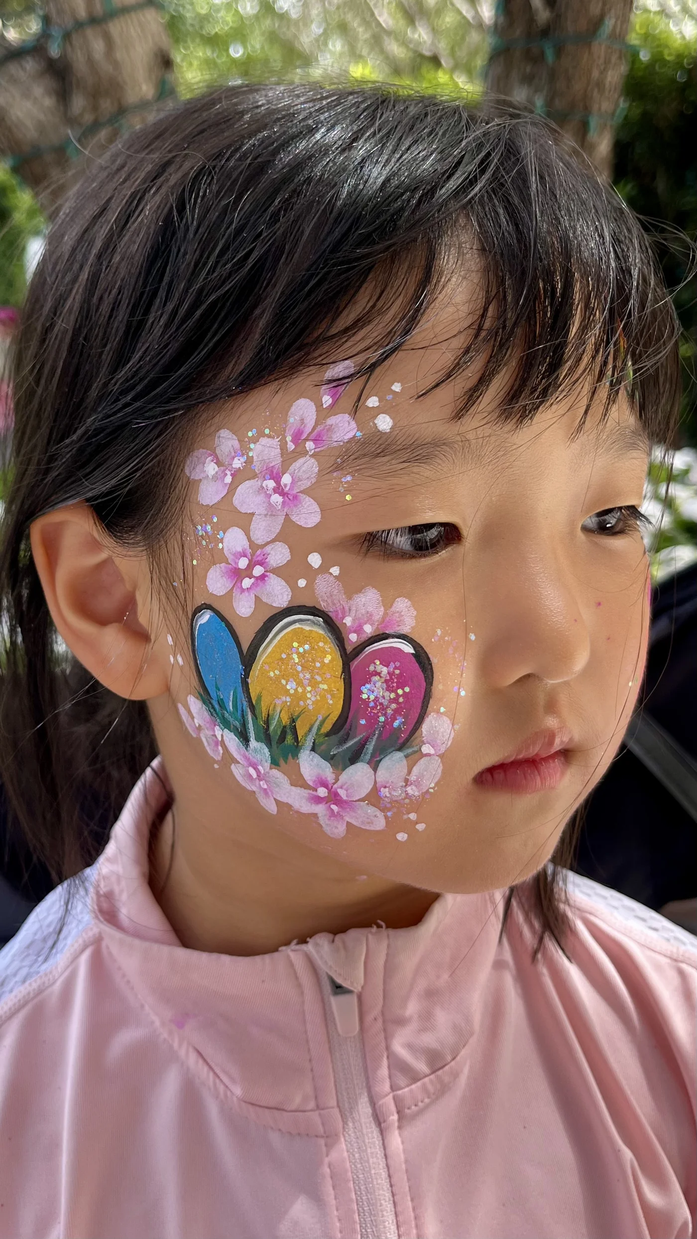 Cherry blossom and Easter egg cheek painting by Happy Faces LA at a birthday party