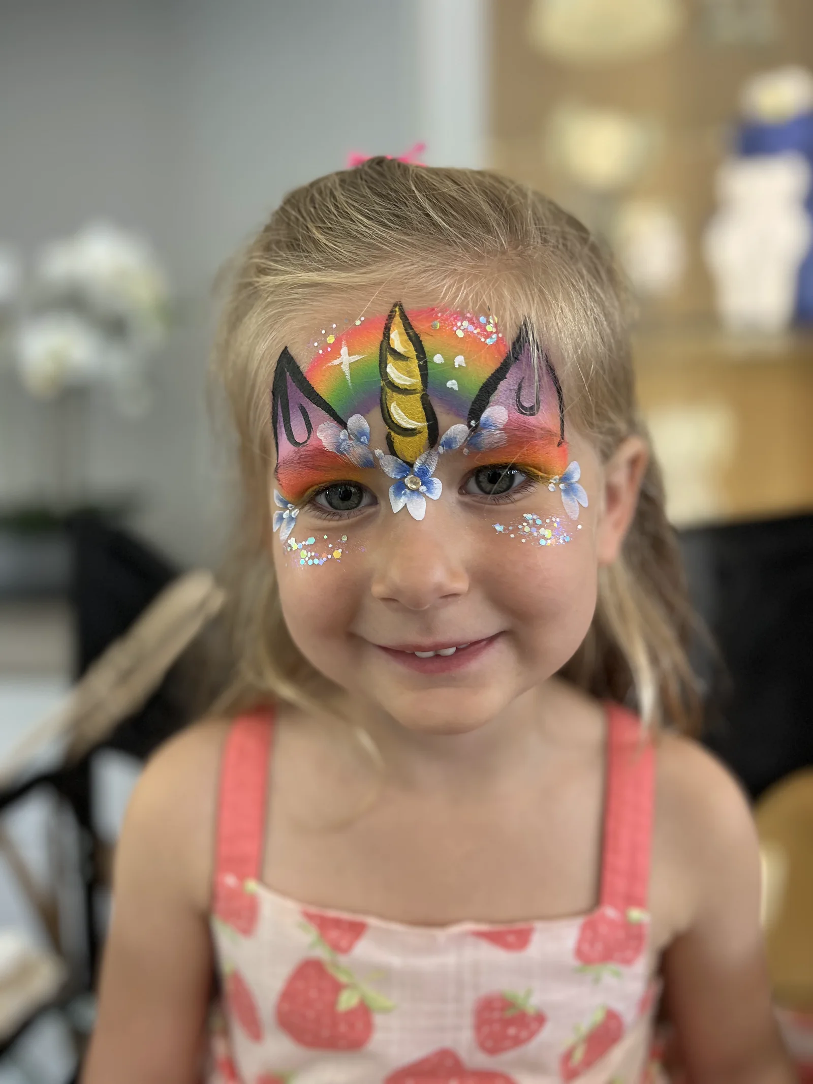 Rainbow unicorn full face painting with glitter and flowers by Happy Faces LA