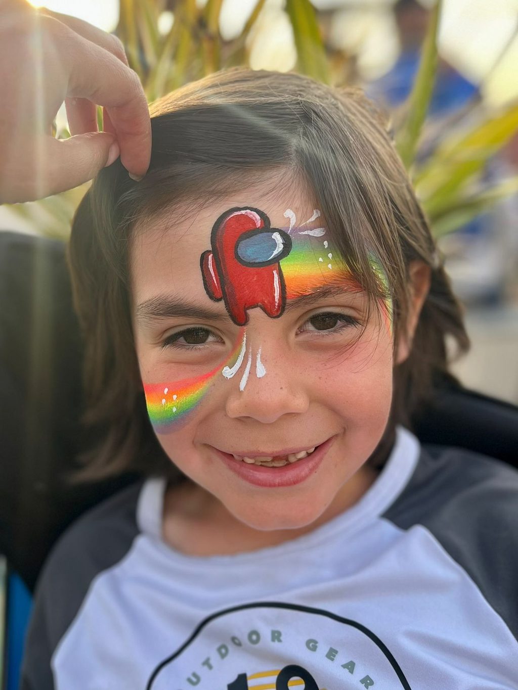 Space Crewmate-Inspired Rainbow Face Painting by Happy Faces LA.