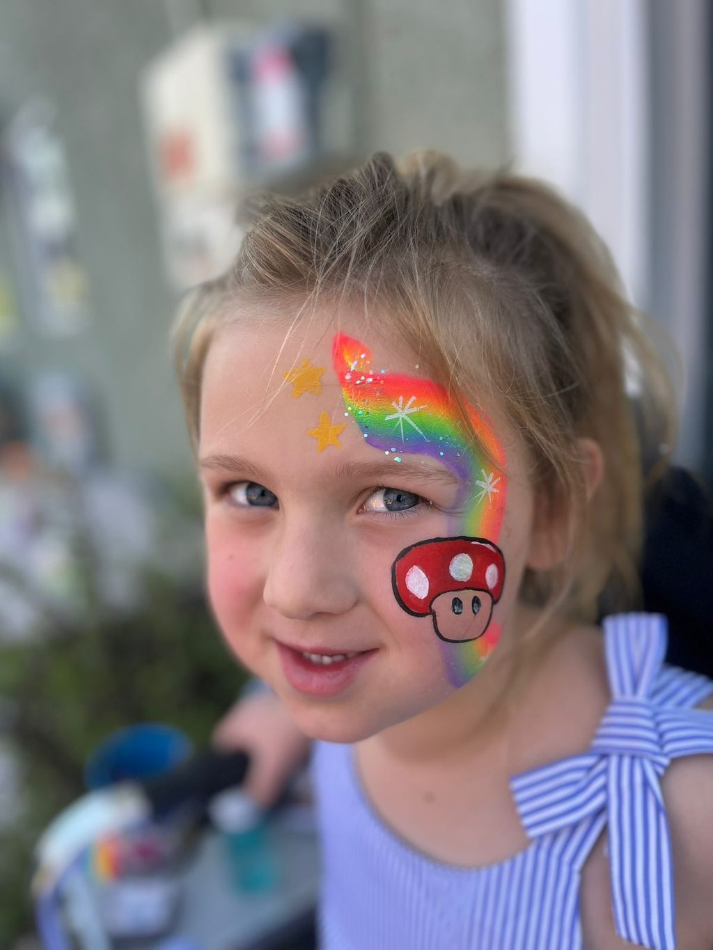 Red Mushroom-Inspired Cheek Art with Rainbow by Happy Faces LA.